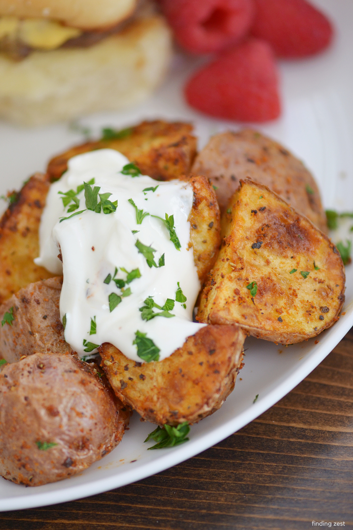 Roasted red potatoes in the air fryer topped with sour cream and parsley.