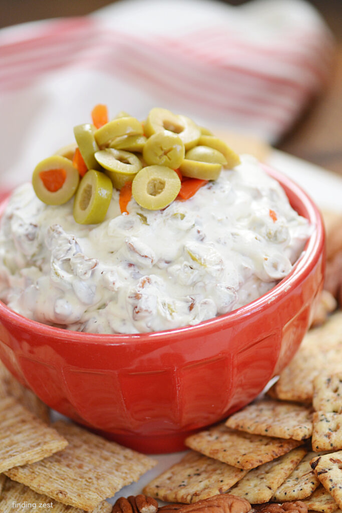 Olive dip is the ultimate party dip recipe! Made with just four ingredients including sliced green olives and chopped pecans, this dip is an easy appetizer that is always a hit! Serve it up with your favorite crackers, bread or veggies.