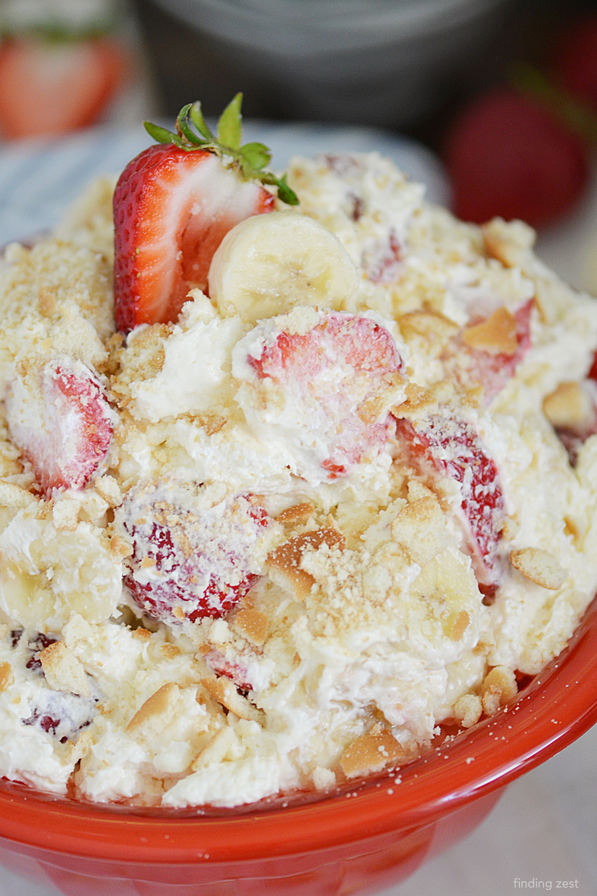 Strawberry Banana Cheesecake Salad is a light fruit salad with cream cheese, fresh strawberries, ripe bananas, pudding and Cool Whip! It is the perfect dessert for any gathering! Try it as a light summer dessert or bbq side dish.