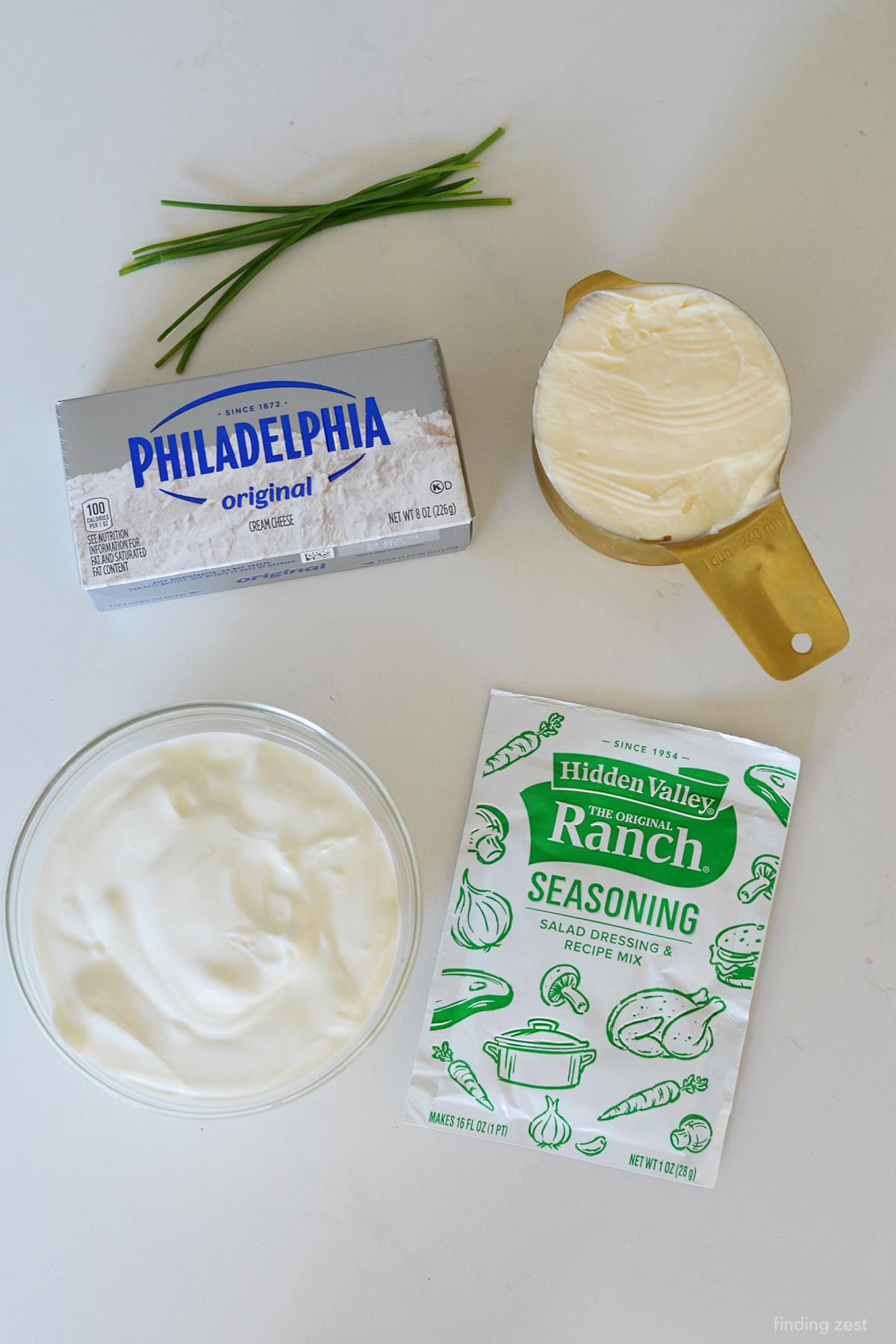 Ingredients for veggie dip with cream cheese, hidden valley ranch seasoning mix, sour cream, and mayo.