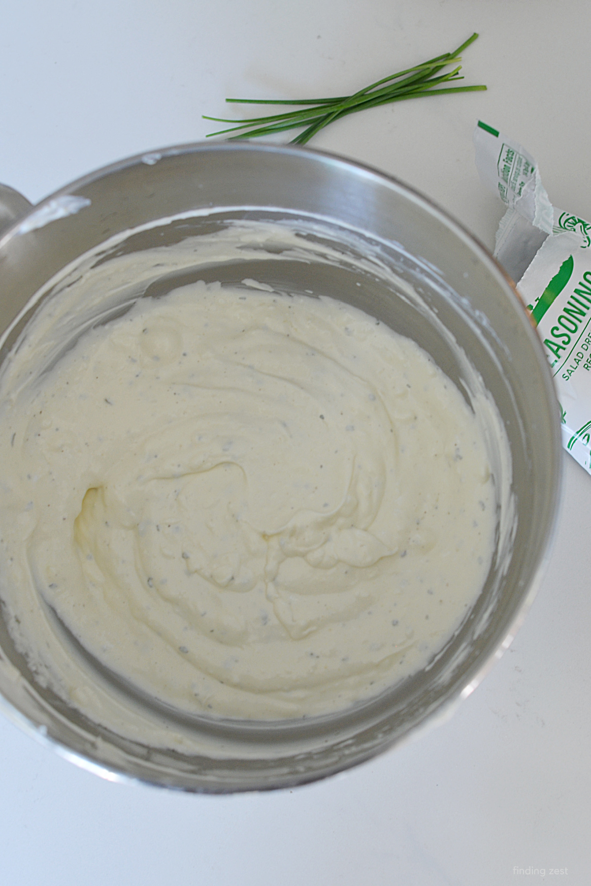 Veggie dip with cream cheese, sour cream, mayo and ranch in a bowl.