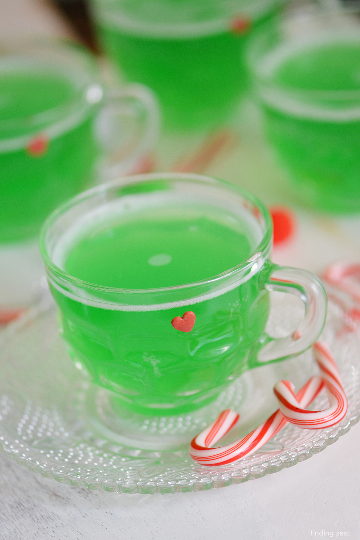 This easy Grinch Punch is sure to be a hit at your next Christmas party or holiday dinner. The Grinch is a classic and this punch plays up the bright green fur and red heart!