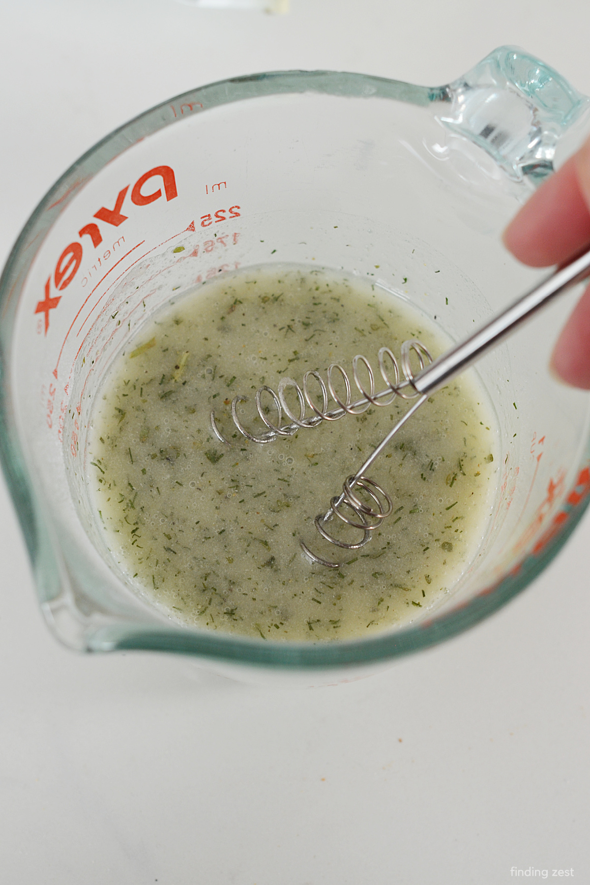 Whisking Hidden Valley Ranch Seasoning Mix with additional dill weed and garlic along with some vegetable oil.