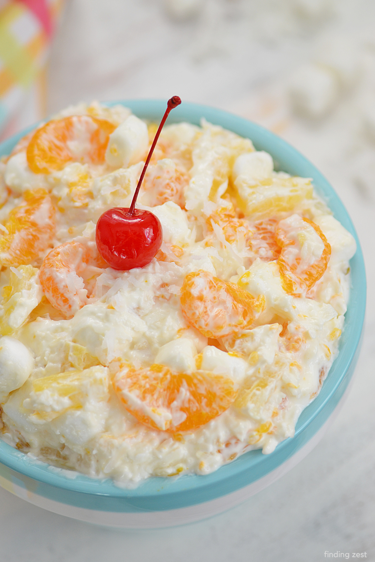 5 Cup Salad is a classic recipe! This creamy fruit salad features canned pineapple, mandarin oranges, coconut, mini marshmallows and tangy sour cream! Otherwise known as Ambrosia salad, it's always a crowd pleaser and a hit at any family gathering including holiday dinners, potlucks, picnics and cookouts.