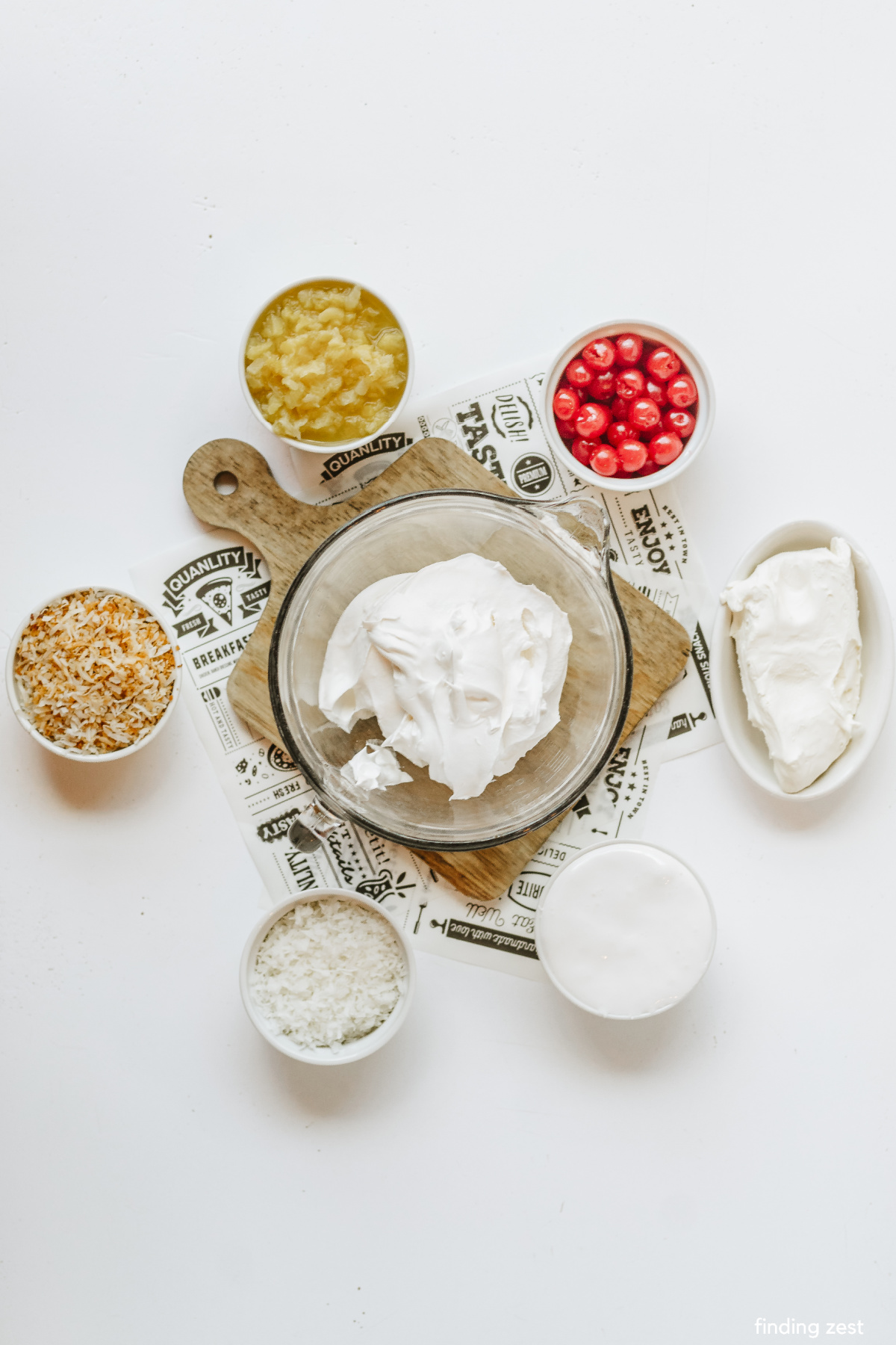 Ingredients to make pina colada dip including cream cheese, crushed pineapple, coconut marshmallow fluff and cool whip.
